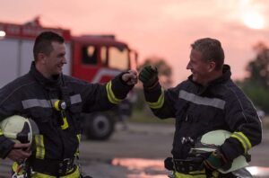 Firefighters fist bumping - Enhancing Well-Being Through Collaboration and Data
