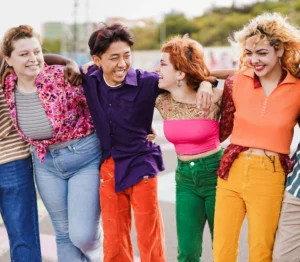 A group of gender-diverse youth stand arm-in-arm. This image is being used for PolicyWise's news story "Turning strategy into action."