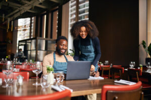 Restaurant managers working with laptop. Alberta food and beverage leaders, join PolicyWise for a free 1.5-hour virtual session for to shape welcoming workplace training. Learn how you can share your expertise! Register by Mar. 18, 2026.