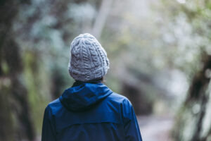 Person outside wearing a grey toque. The image is for PolicyWise news story on building data infrastructure to prevent youth homelessness.