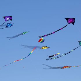 Variety of colorful Kites in a clear blue sky at the Wildwood Kite Festival in New Jersey