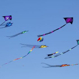 Variety of colorful Kites in a clear blue sky at the Wildwood Kite Festival in New Jersey